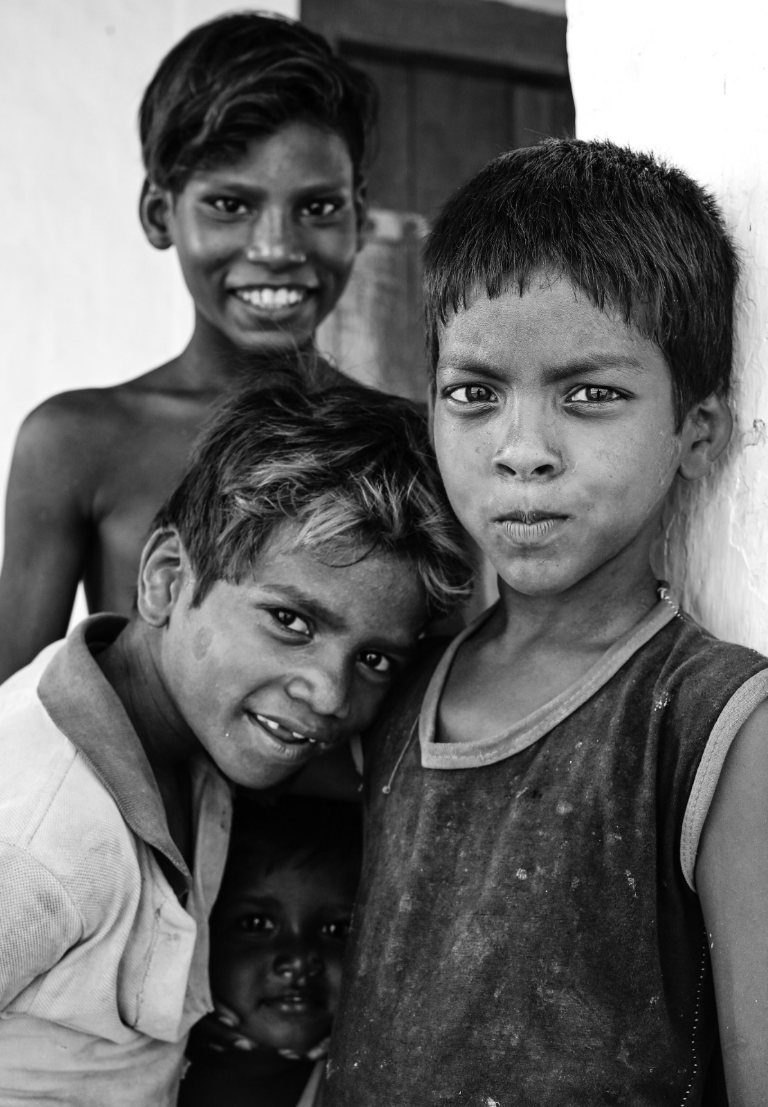 Three young boys from a community we support, looking to the camera