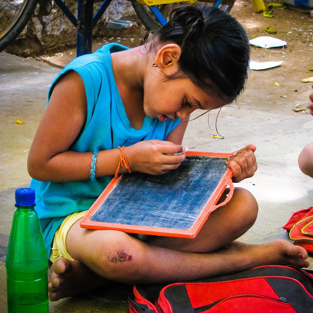 Meera writing at school